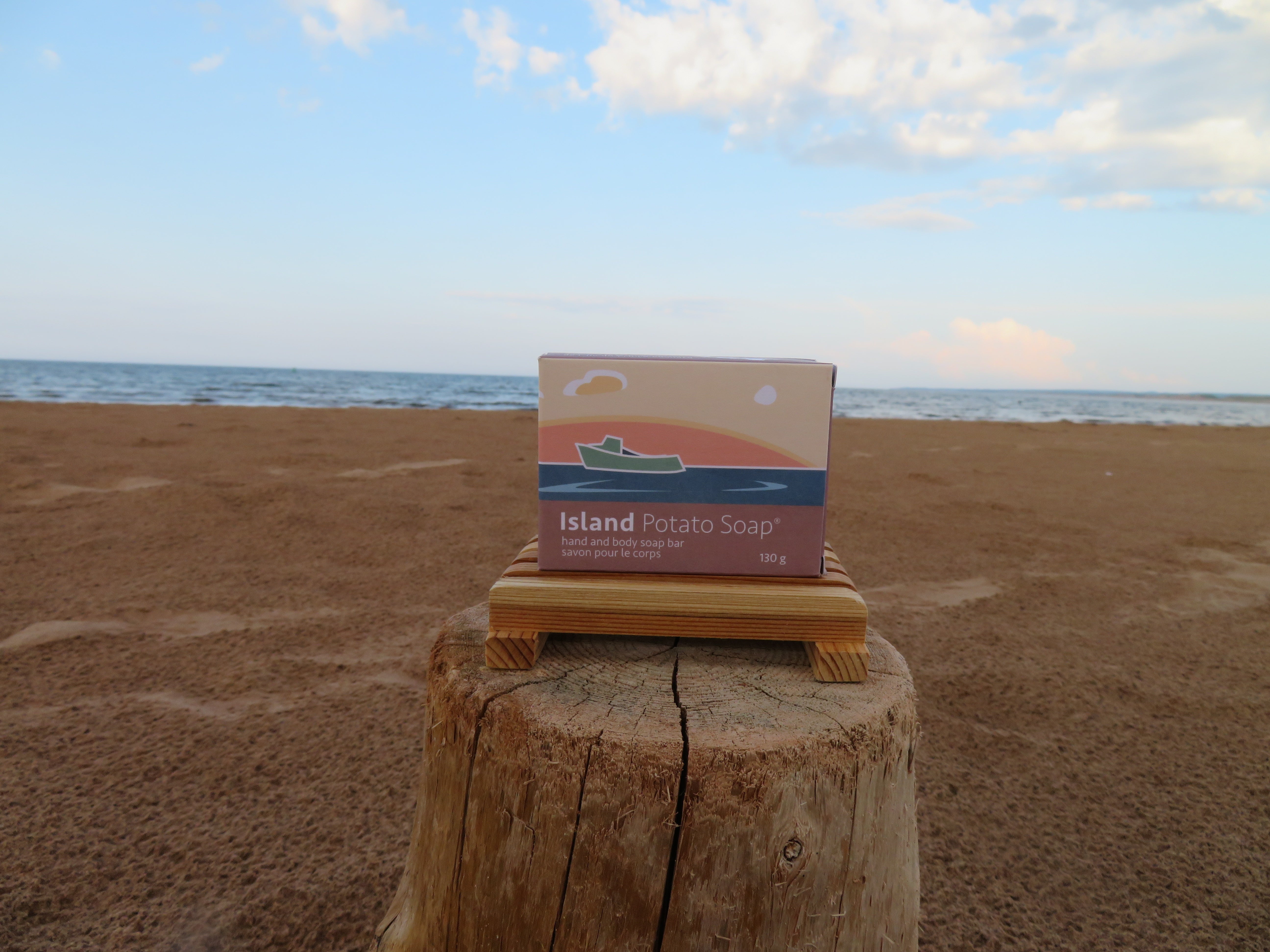 Box of Island Potato Soap on a wooden block with ocean and sky in the background