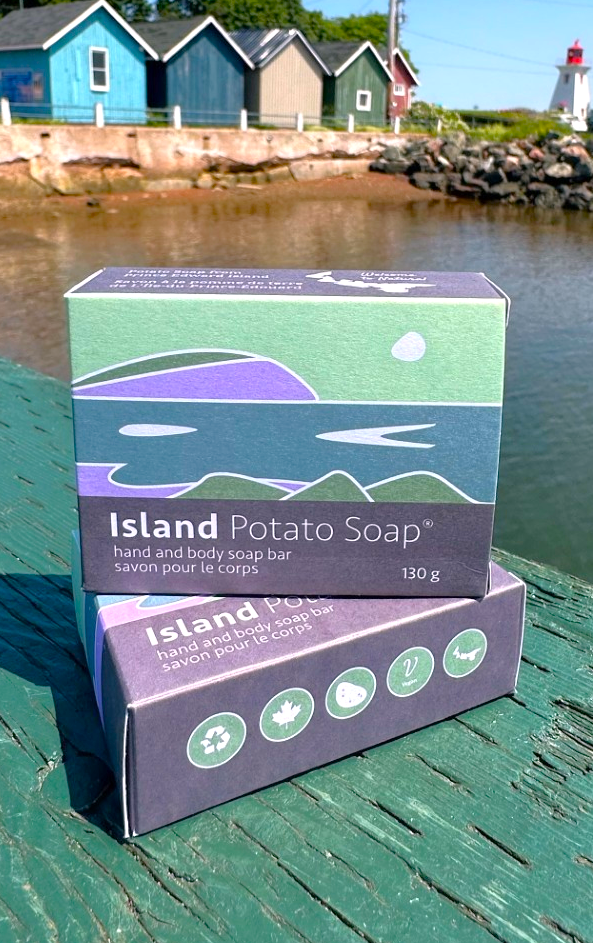 Island Potato Soap packaging on a wooden surface with a scenic background