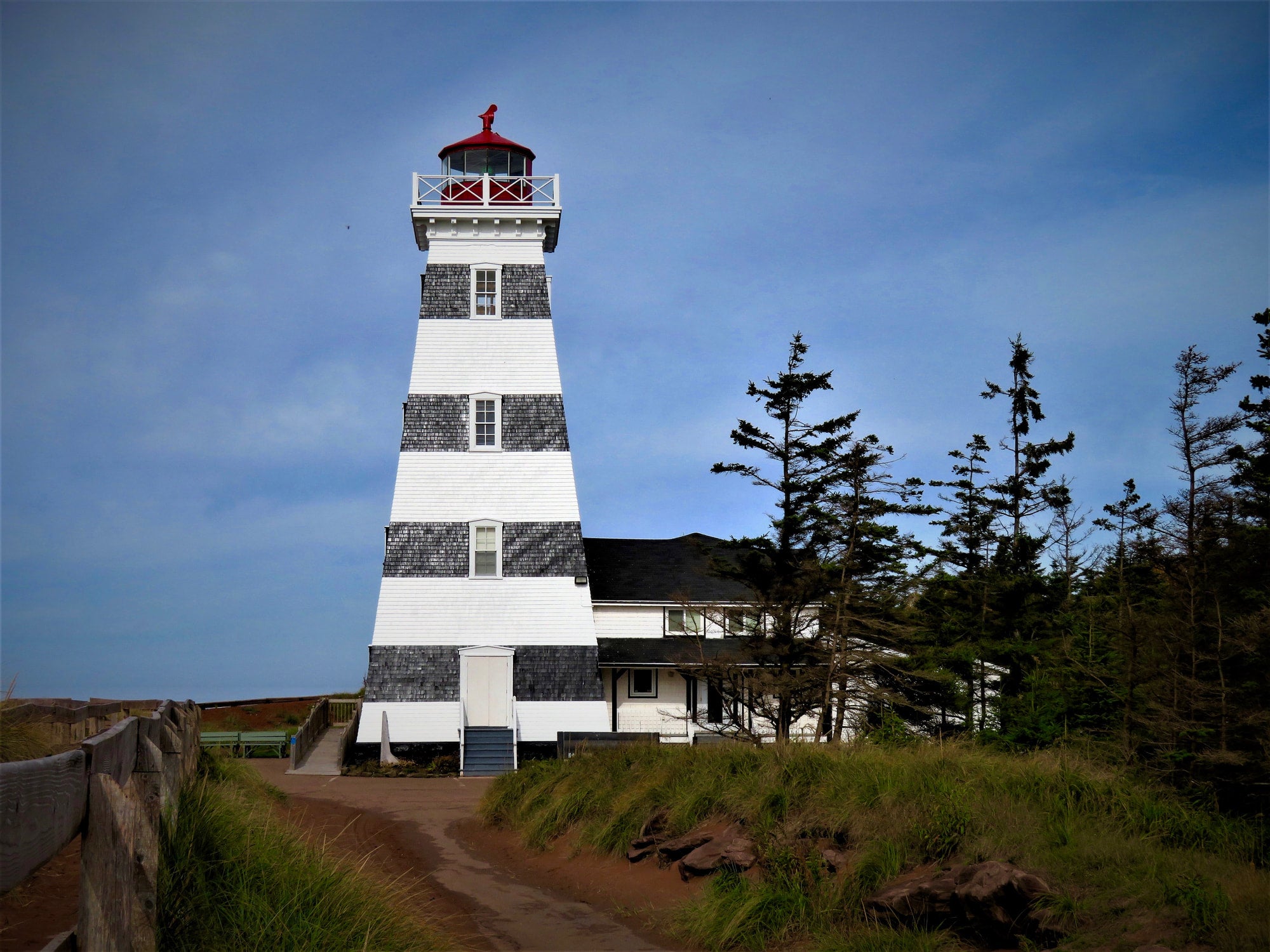 Lighthouse with black and white striped design on a clear day