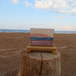 Box of Island Potato Soap on a wooden block with ocean and sky in the background