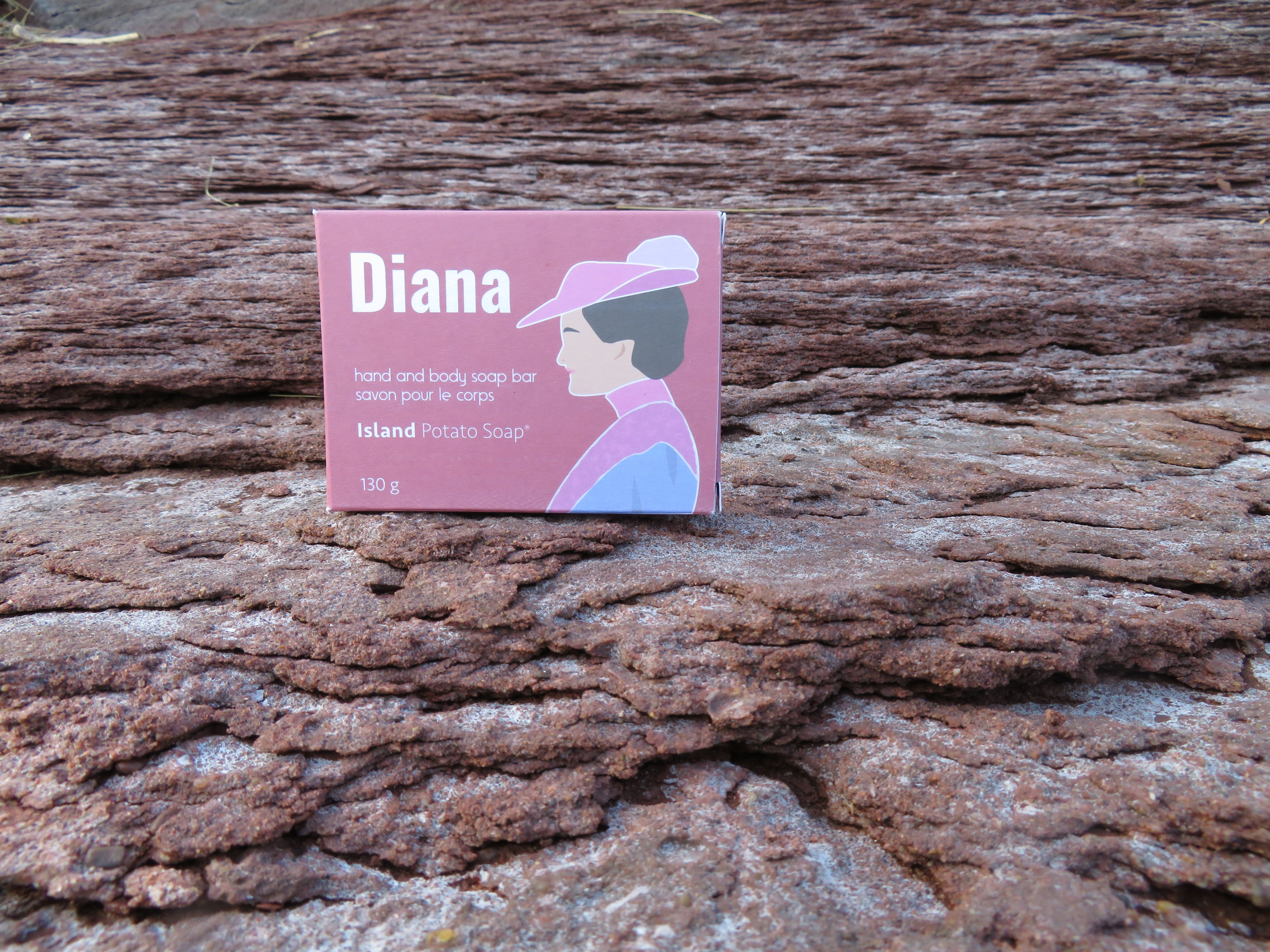 Diana brand product packaging on a wooden surface