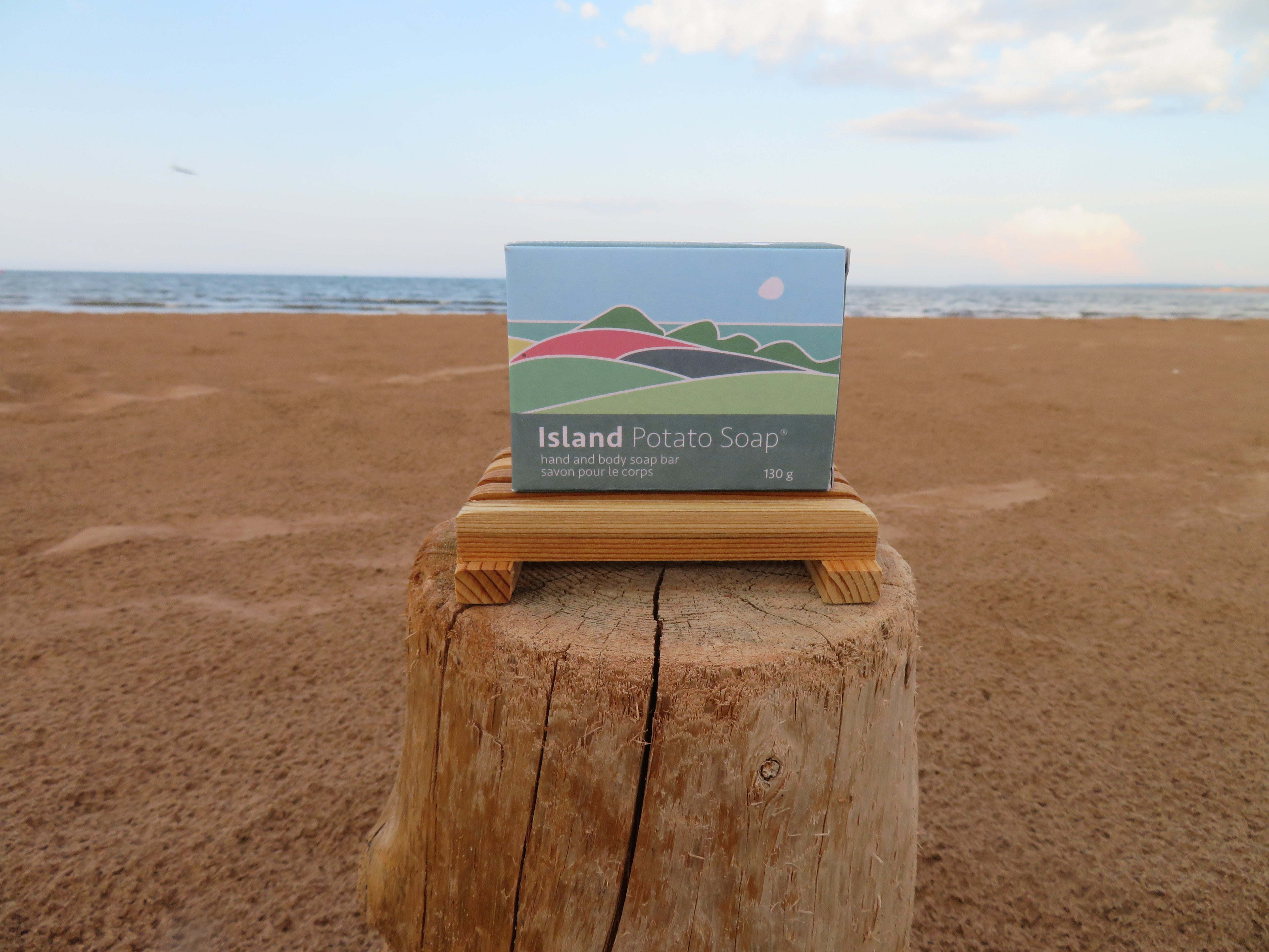 Box of Island Potato Soap on a wooden block with a beach background