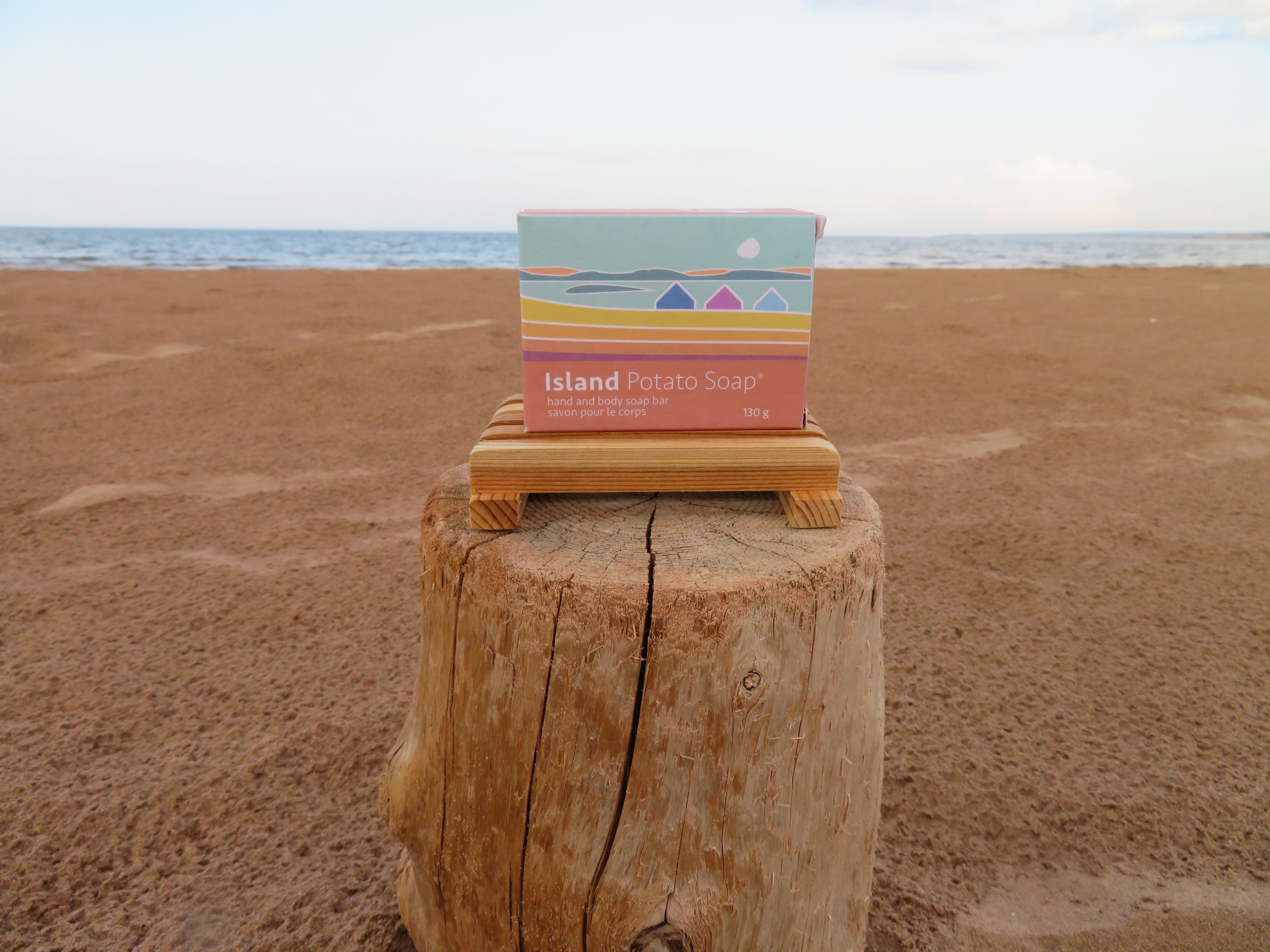 Box of Island Potato Soap on a wooden block with a beach background