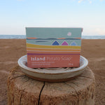 Island Potato Soap packaging on a beach with ocean view