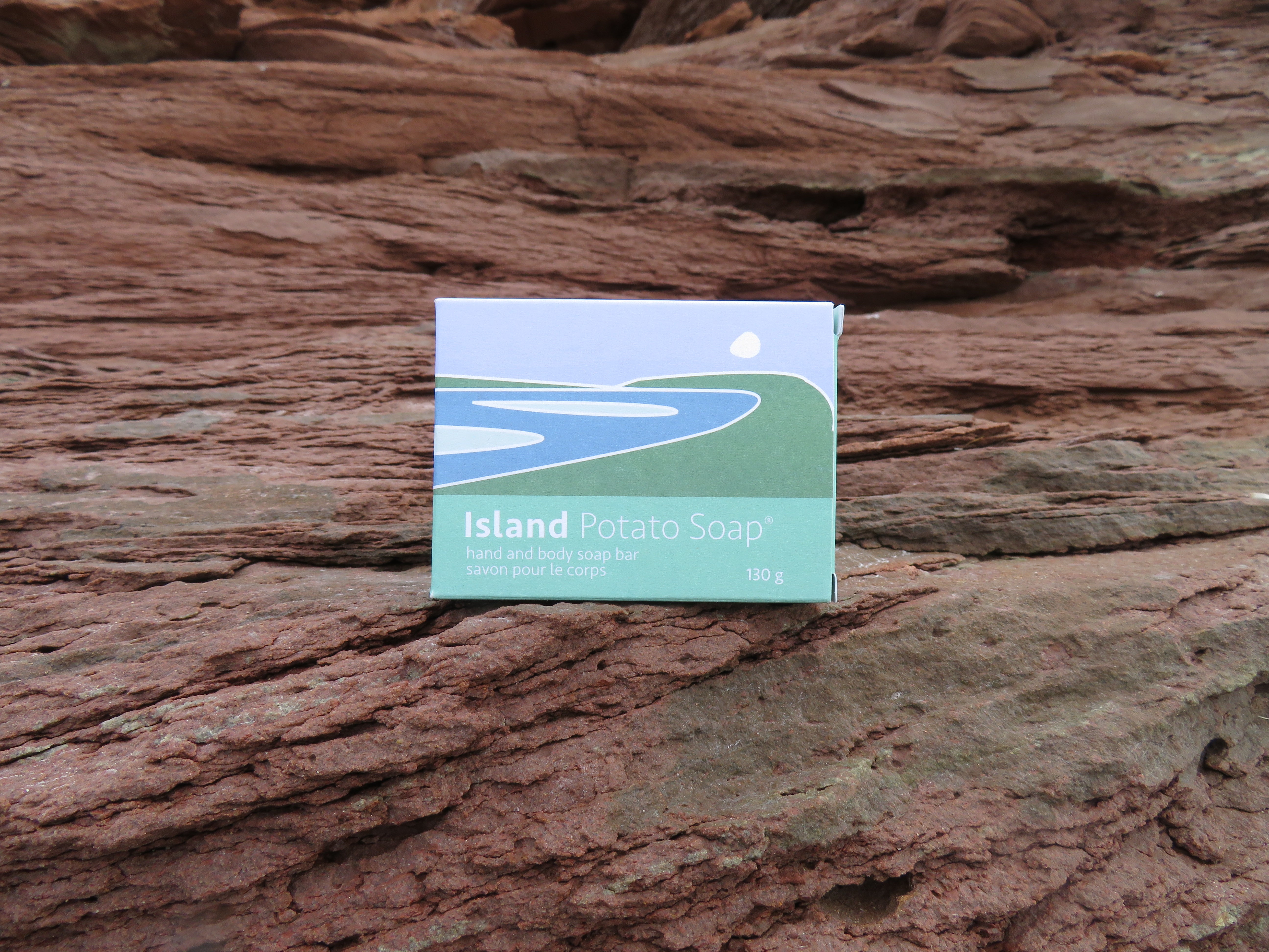 Box of Island Potato Soap on a textured stone surface