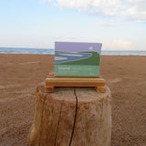 Box of Island Potato Soap on a wooden block with ocean and sky in the background