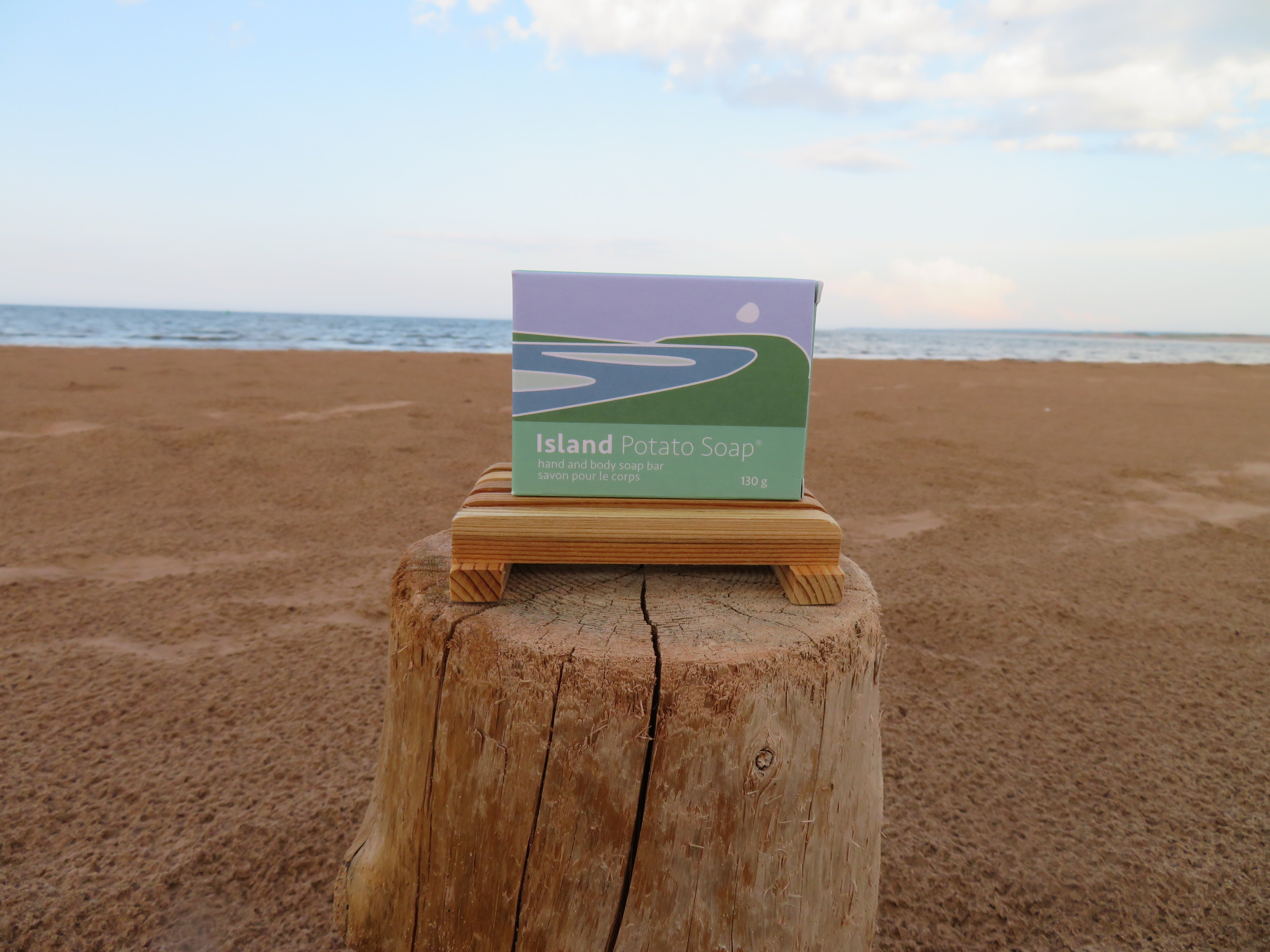 Box of Island Potato Soap on a wooden block with ocean and sky in the background