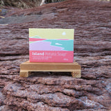 Island Potato Soap packaging on a wooden stand against a natural background
