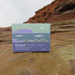 Box of Island Potato Soap on a rocky surface