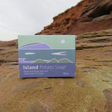 Box of Island Potato Soap on a rocky surface