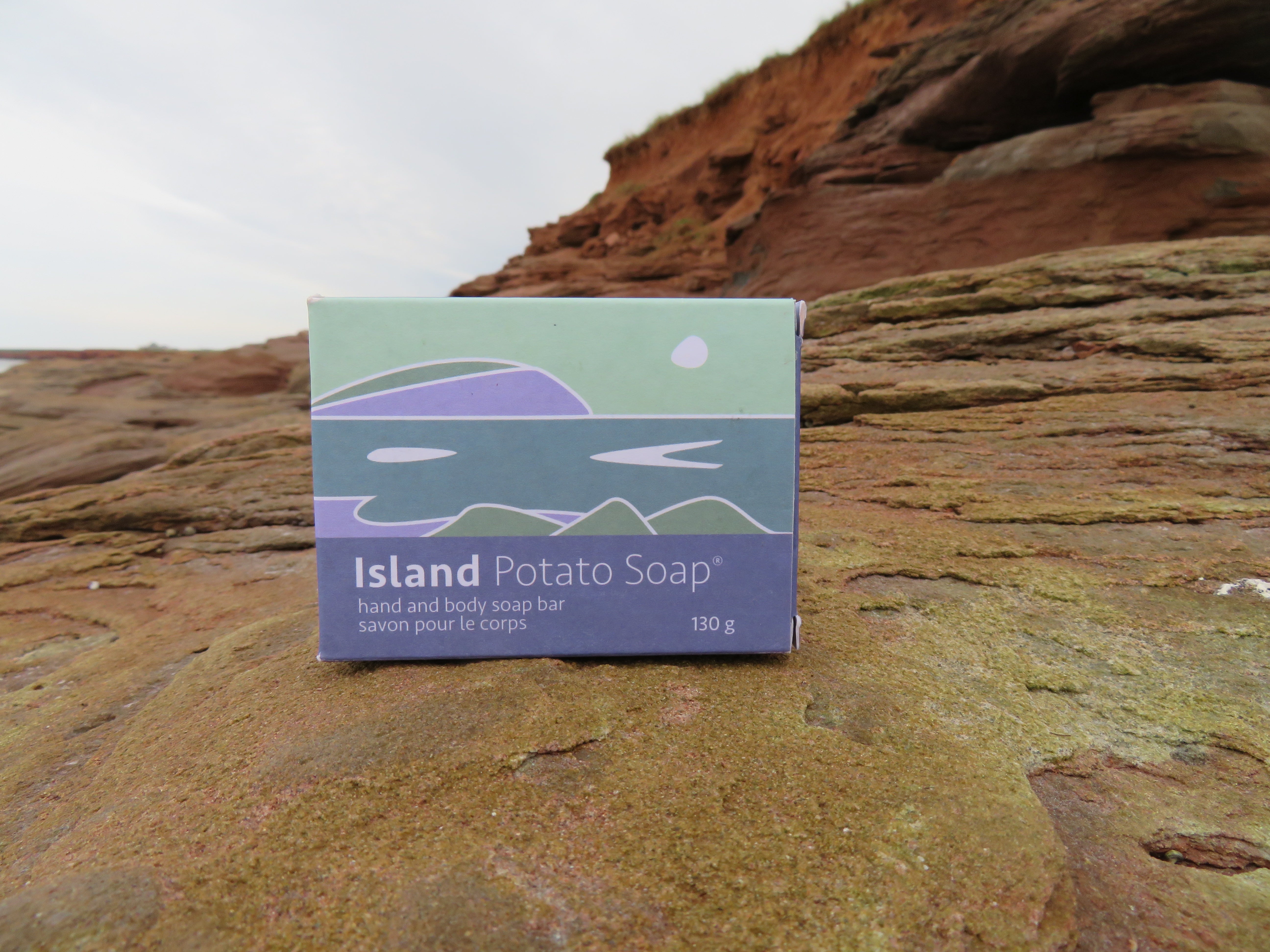 Box of Island Potato Soap on a rocky surface